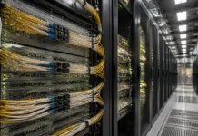 ITU-T Standardizes Low Latency Energy Efficient Networks Row of server racks in a data center with yellow network cables and blinking lights on the equipment front panels.