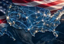 U.S. Senators Introduce Bill to Strengthen Telecommunications Cybersecurity United States map at night with glowing network lines and bright city lights, enhanced by a waving American flag backdrop