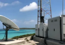 Starlink Gains 15-Year Licence for Satellite Telecom Connectivity Satellite dish and telecom cabinets installed on a coastal site with turquoise ocean in the background